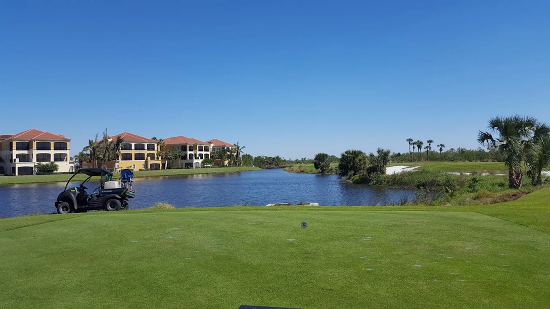 Hammock Bay Golf Course in Naples FL with water view and golf cart via Grok