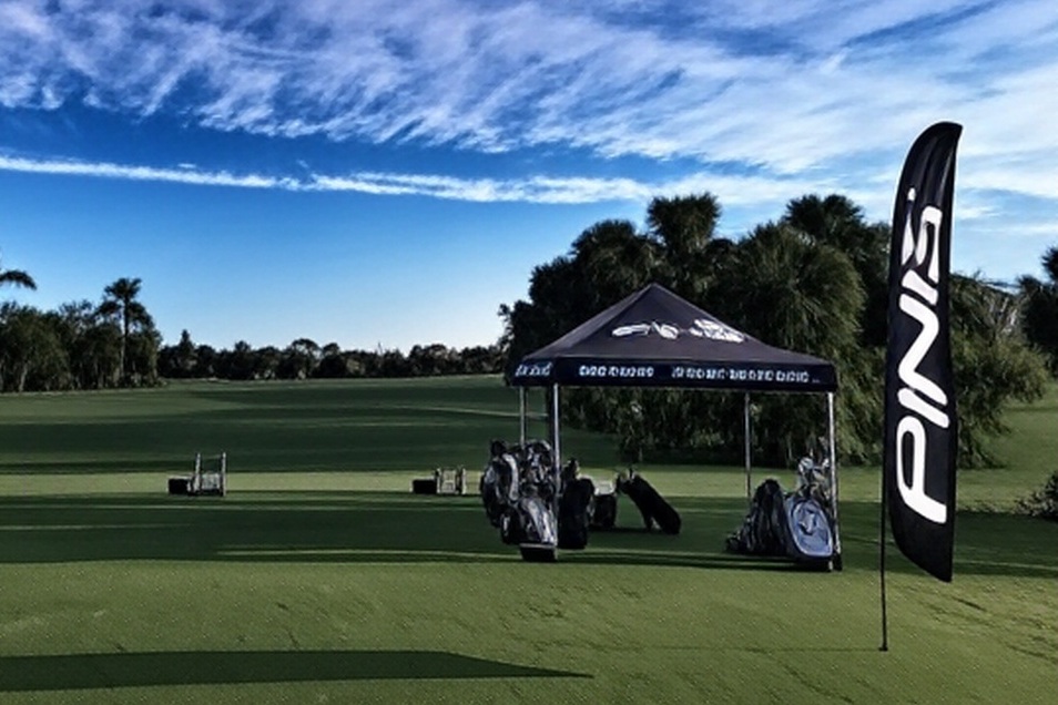 Hole-in-the-Wall Golf Club in Naples Florida driving range view with demo tent via Grok