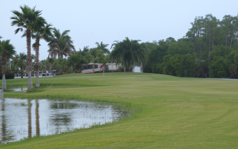 Silver Lakes RV Resort & Golf Club in Naples Florida view of putting green with water in front via Grok