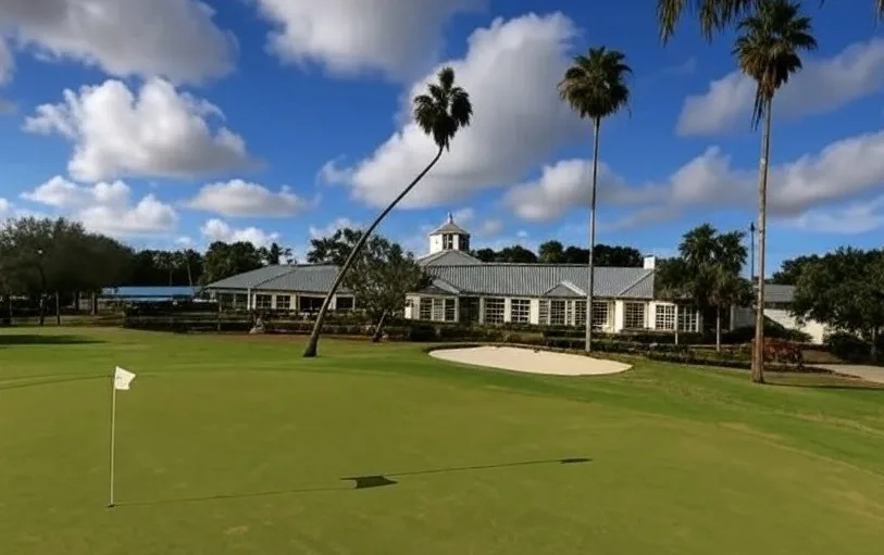 Delray Beach Golf Club in Florida view of clubhouse with green and flagstick in foreground via Grok