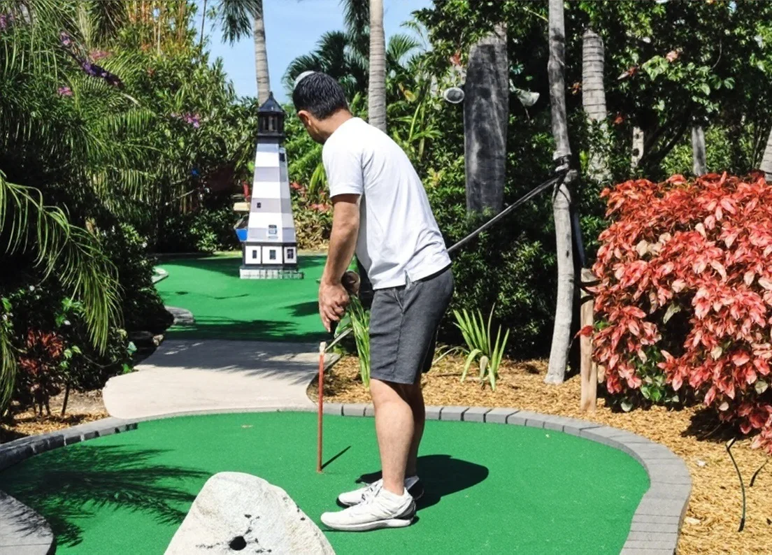 Putt'n Around in Delray Beach Florida view of lighthouse mini golf hole with golfer via Grok