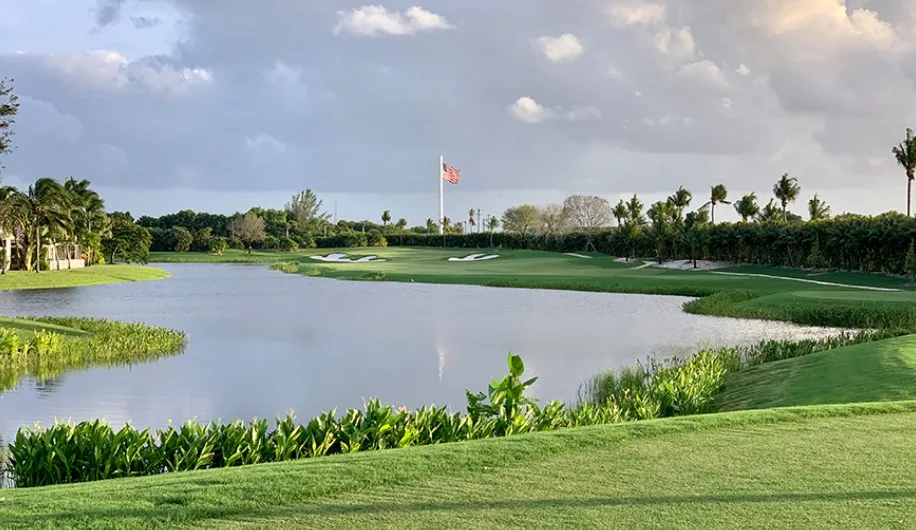 Woodfield Country Club in Boca Raton Florida view of green from fairway with American flag in background